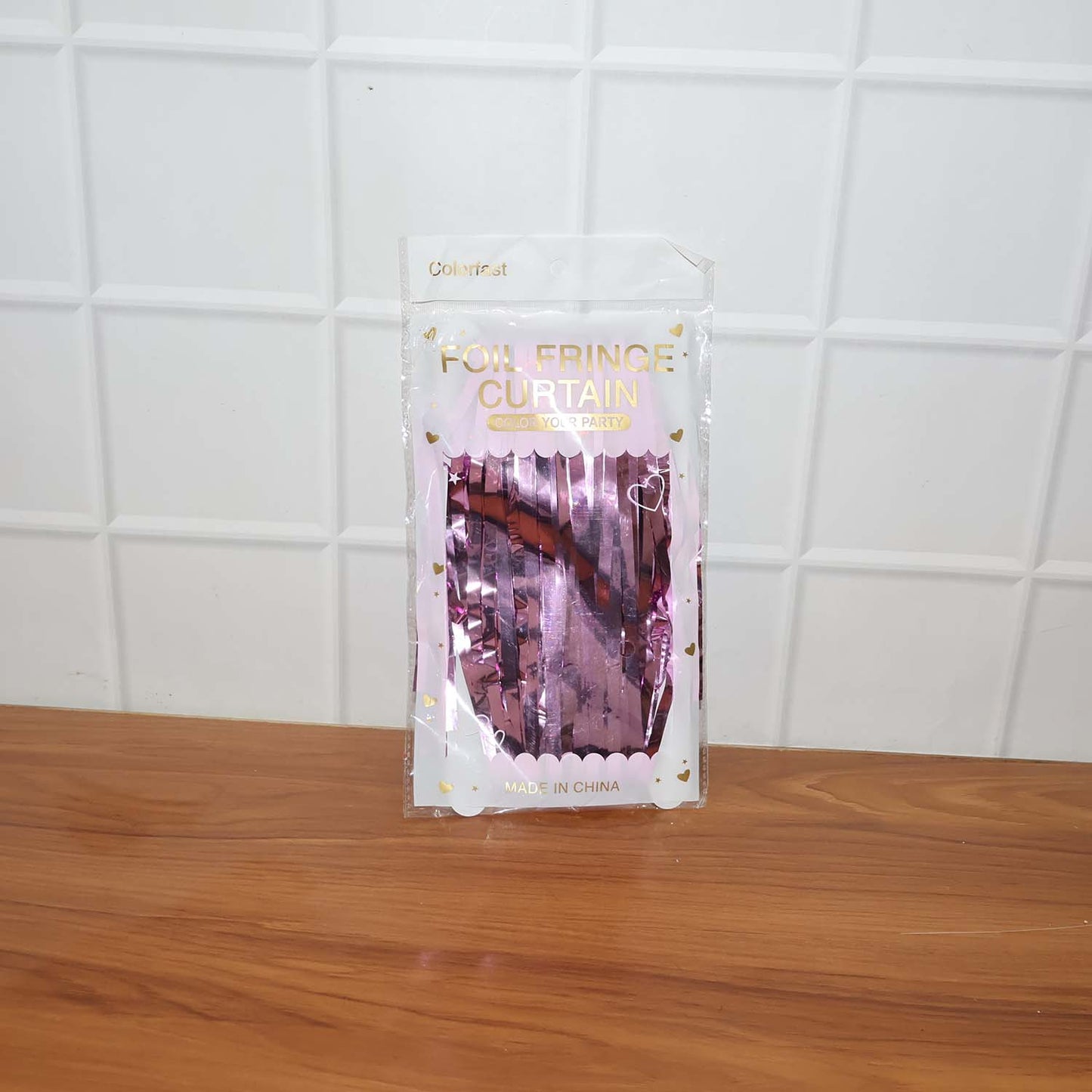 Person posing in front of a sparkling foil fringe curtain photo booth backdrop.