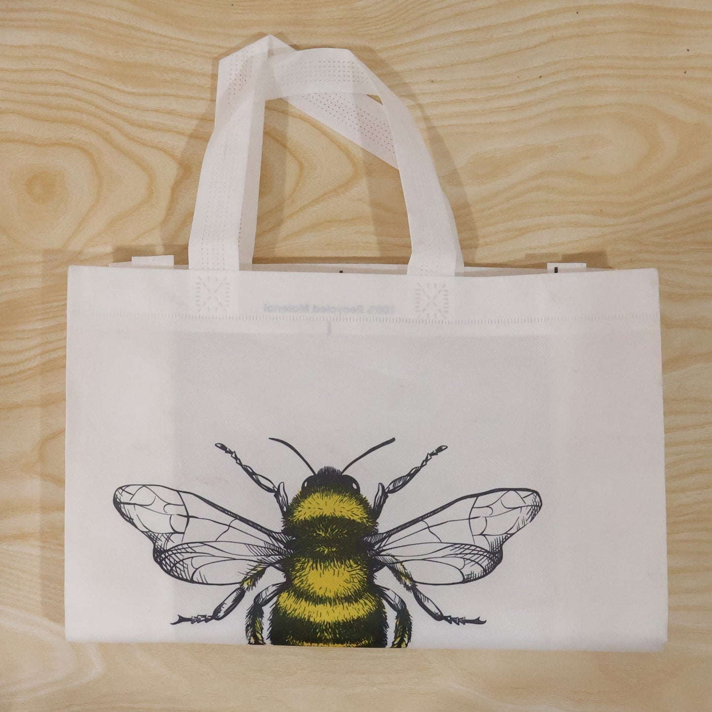 Top view of bee print tote bag showing material and design