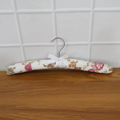 Close-up of floral bow detail on premium satin-padded clothes hanger