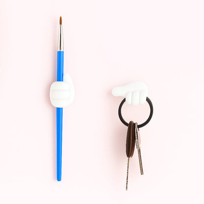 White multifunctional hand-shaped wall clip organizing various small items