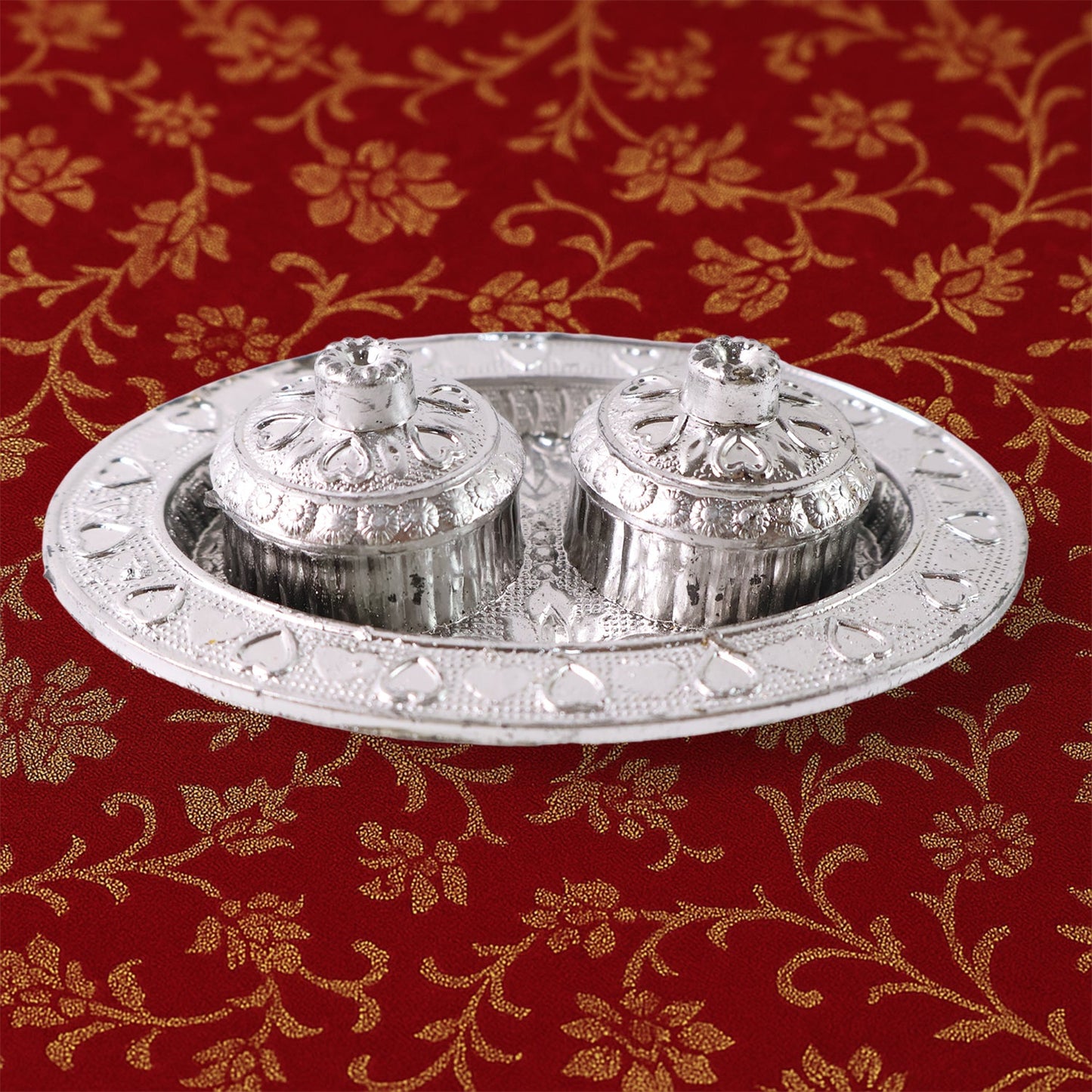 Oval kumkum holder on decorative puja thali