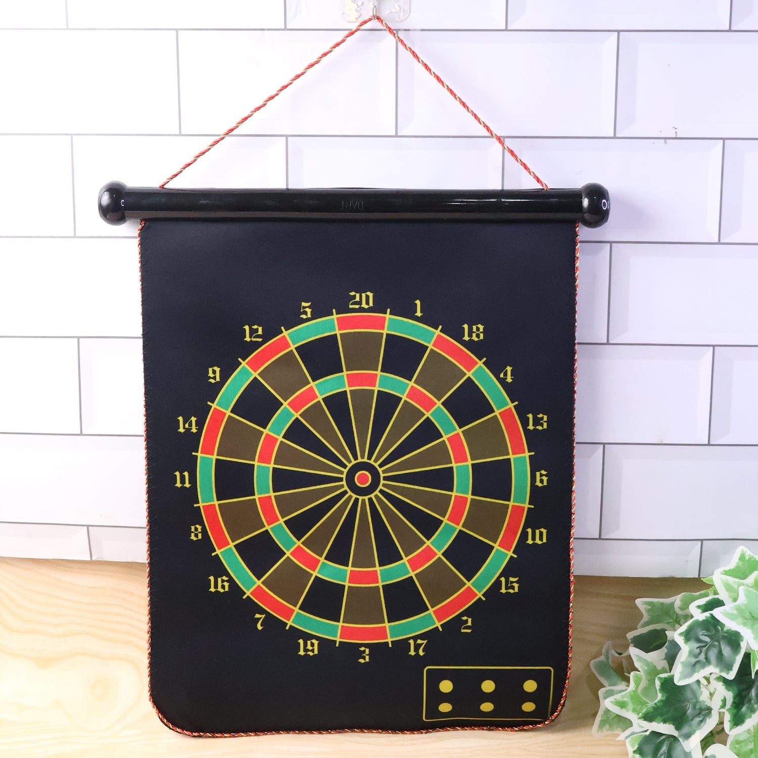 Foldable magnetic dart board set with double-sided design hanging on wall