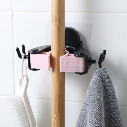 Wall mounted clip holder for mop and broom in use