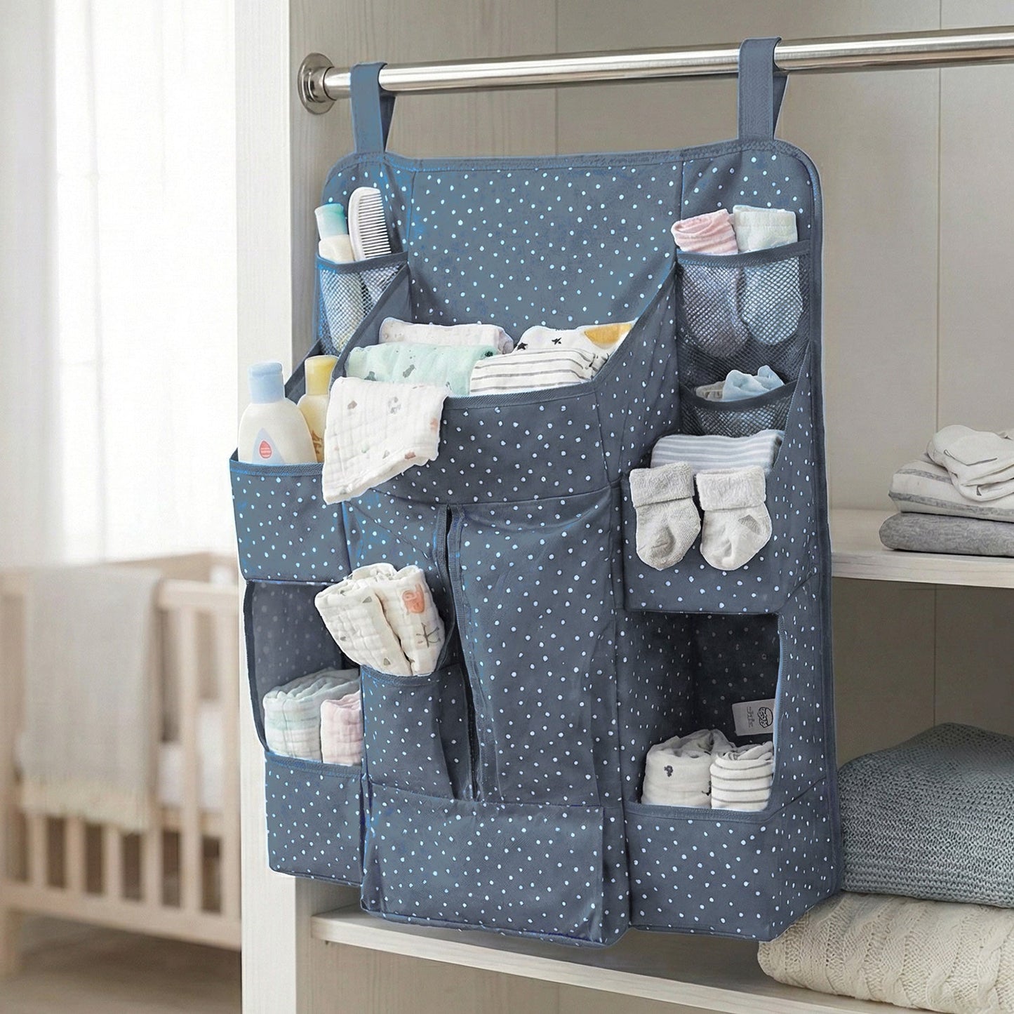 Close-up of storage pockets in baby care organizer for bottles and lotions