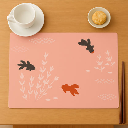 Set of decorative dining table placemats with fish design on a table