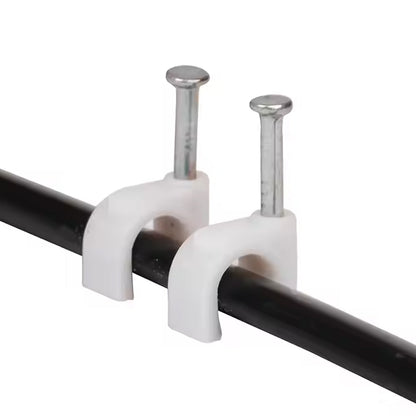 Close-up of plastic U-shaped 8mm nail cable clips with steel nails