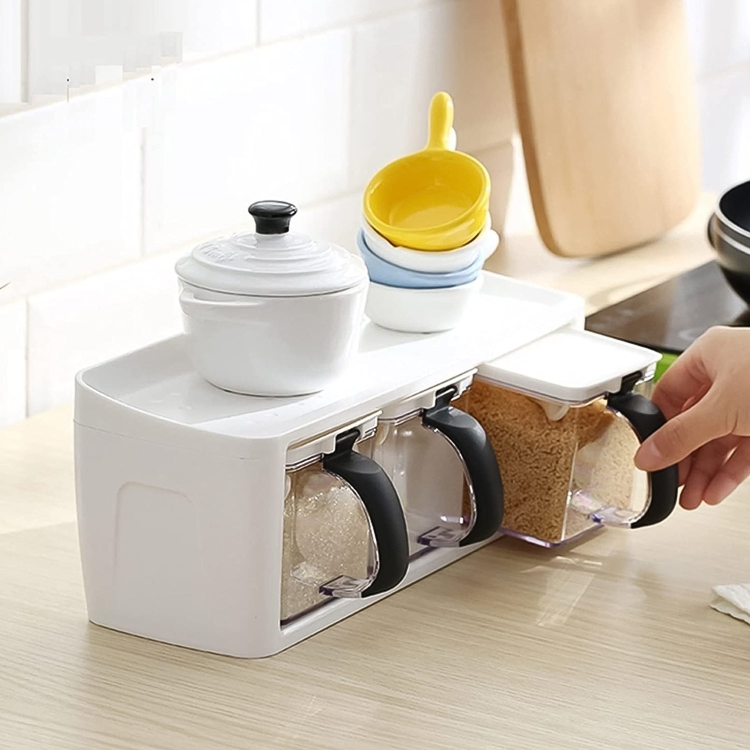 Modular spice storage box set with stand and measuring spoons on kitchen counter