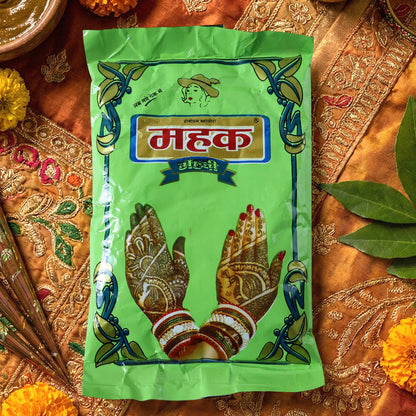 Woman applying Herbal Mehndi Powder paste to hand showcasing henna art
