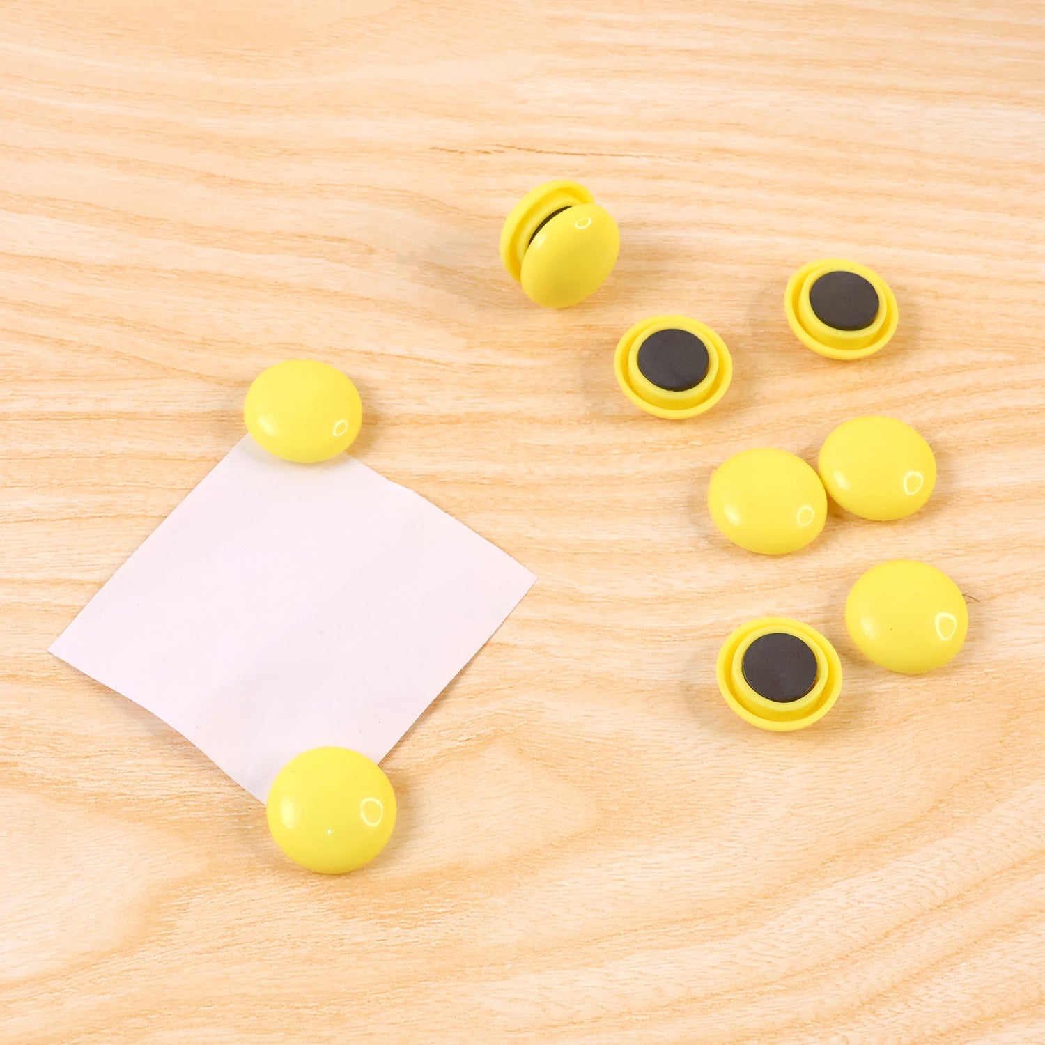 Side profile of a white round magnet, highlighting its compact and sleek design.