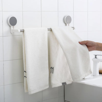 Towel rack bar installed on bathroom wall using adhesive mount