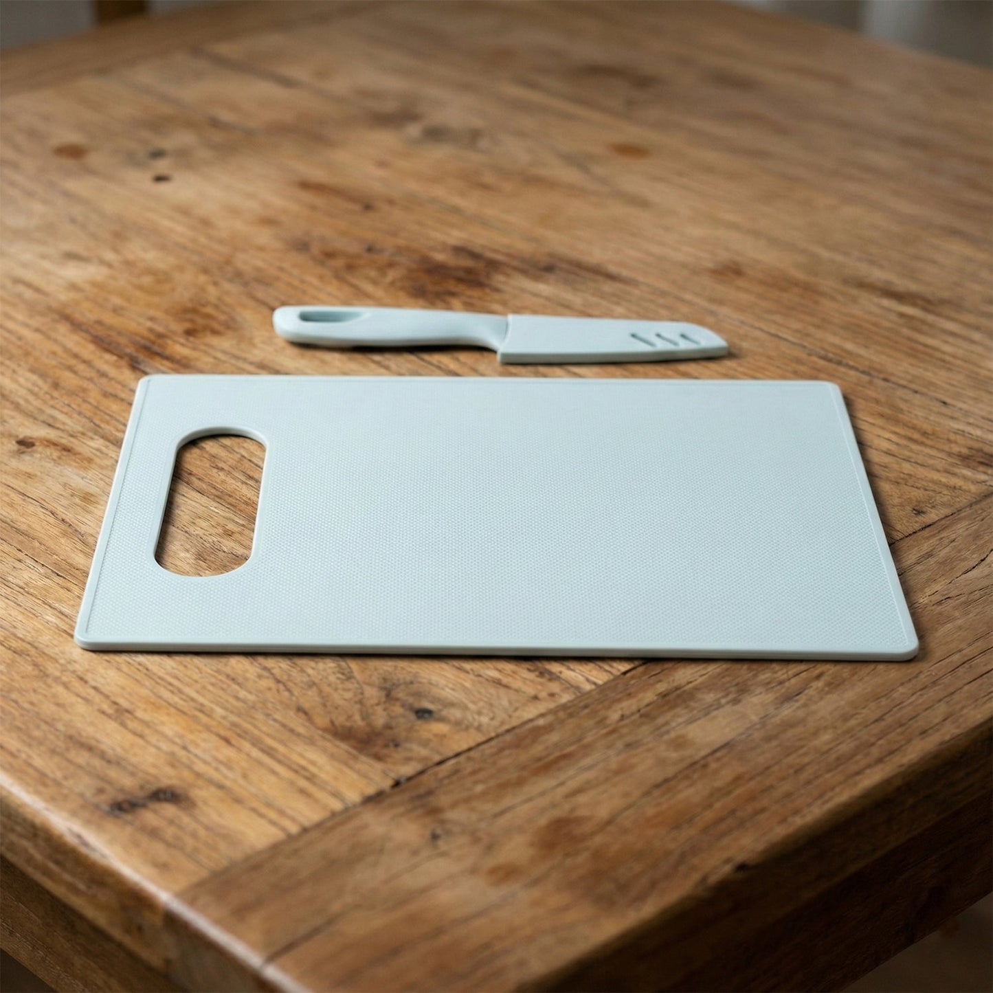 Ergonomic chopping board shown with matching kitchen knife for home cooking