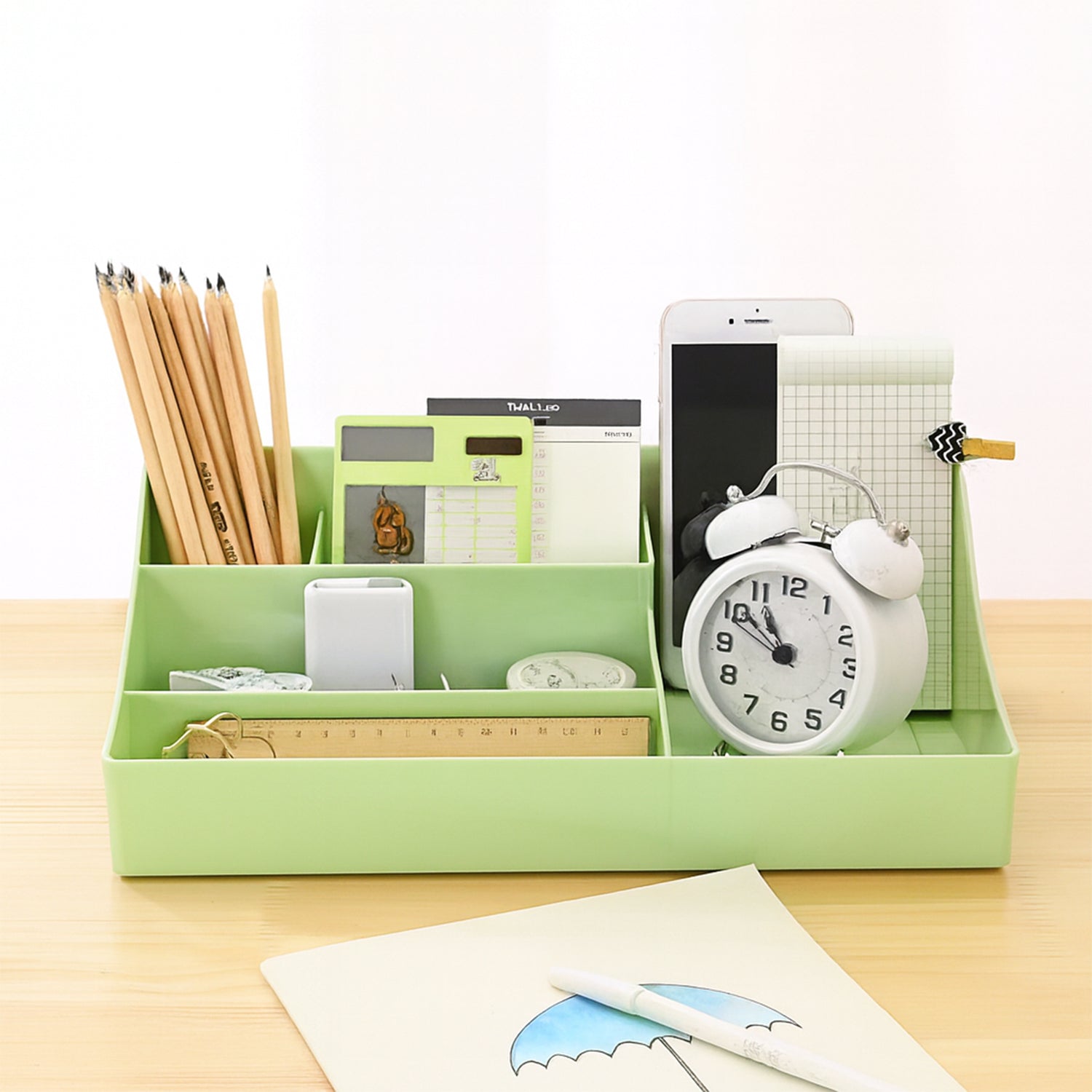 Green storage tray designed as a desk organizer with ventilated base