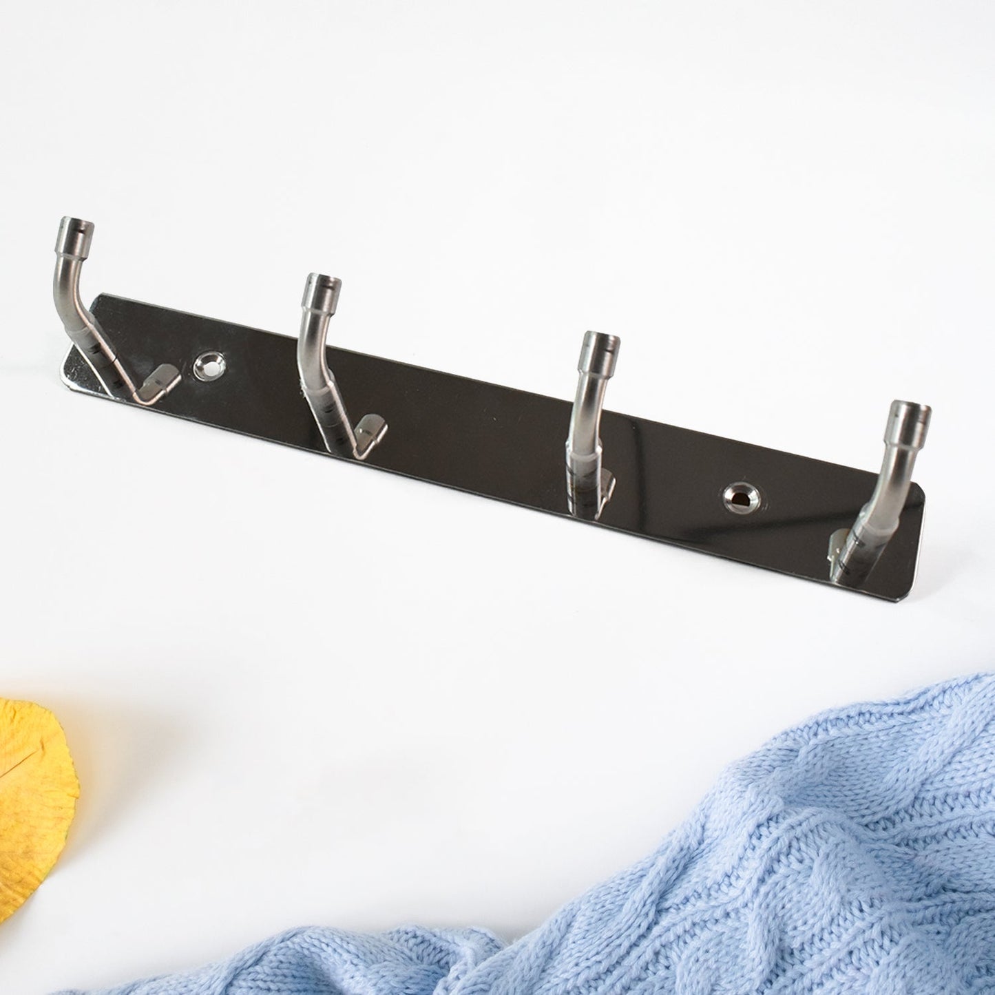 Wall mounted stainless steel hook rack used in entryway for coats and keys