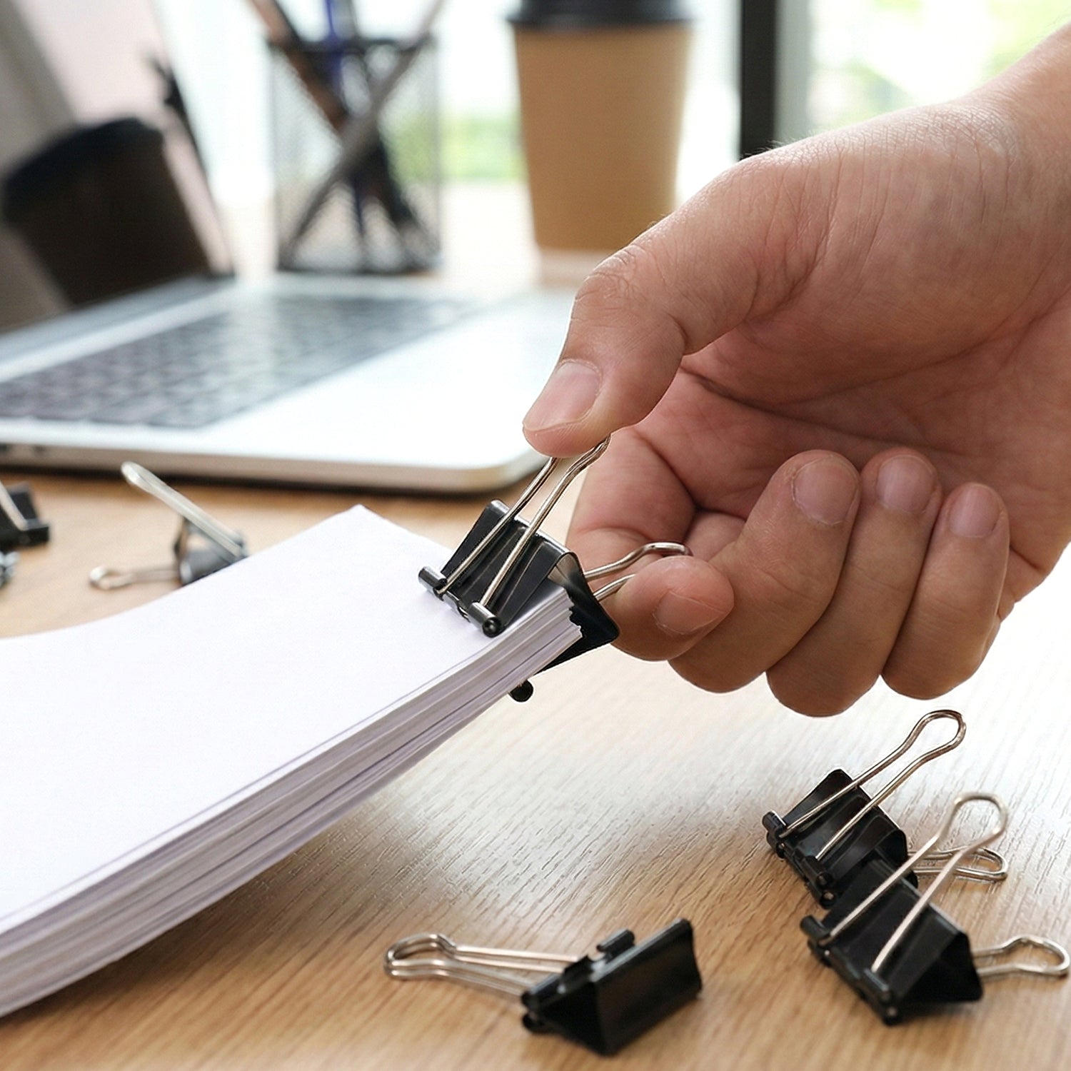 Detailed view of black heavy duty metal binder clips with smooth handles
