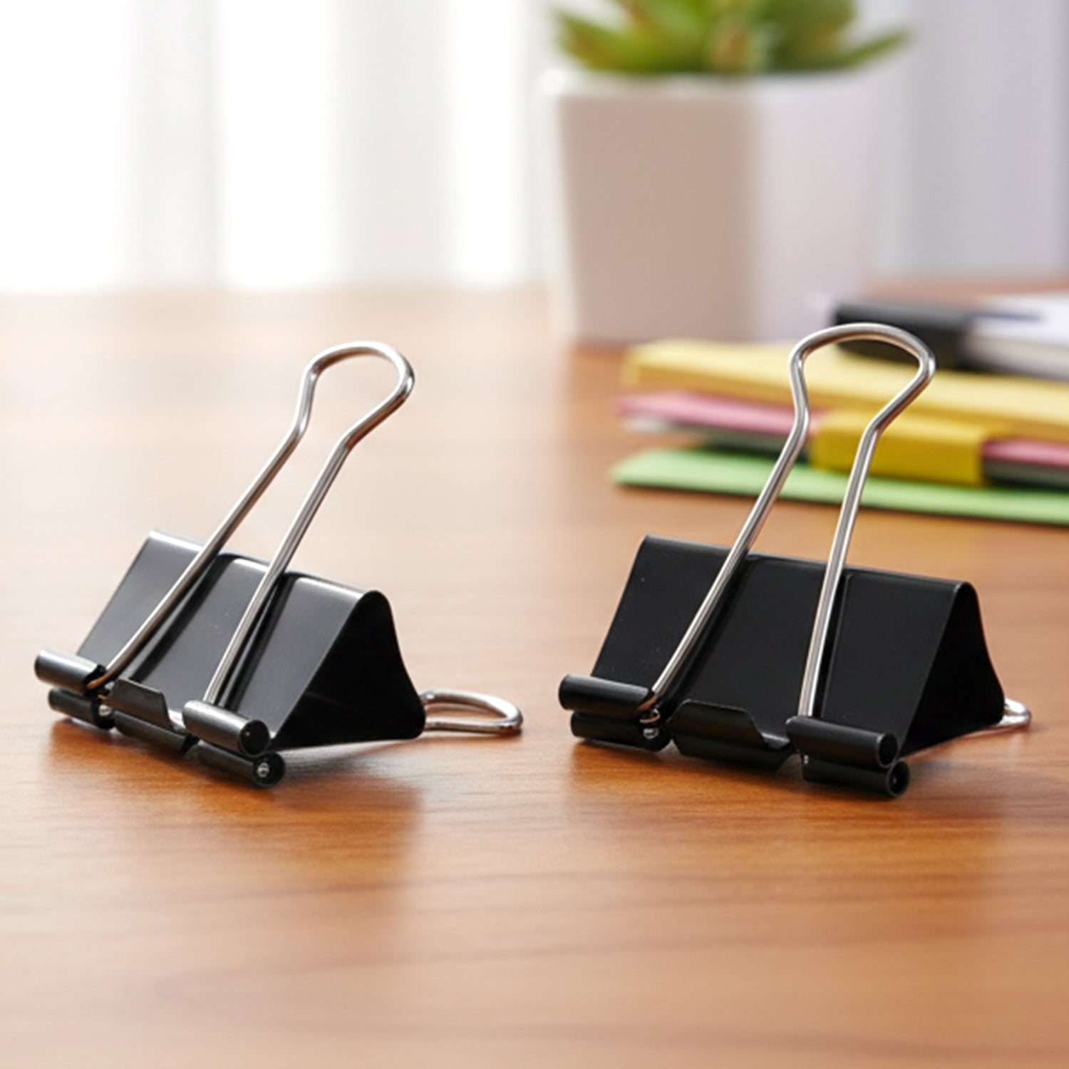 Durable metal binder clips holding bills and notes