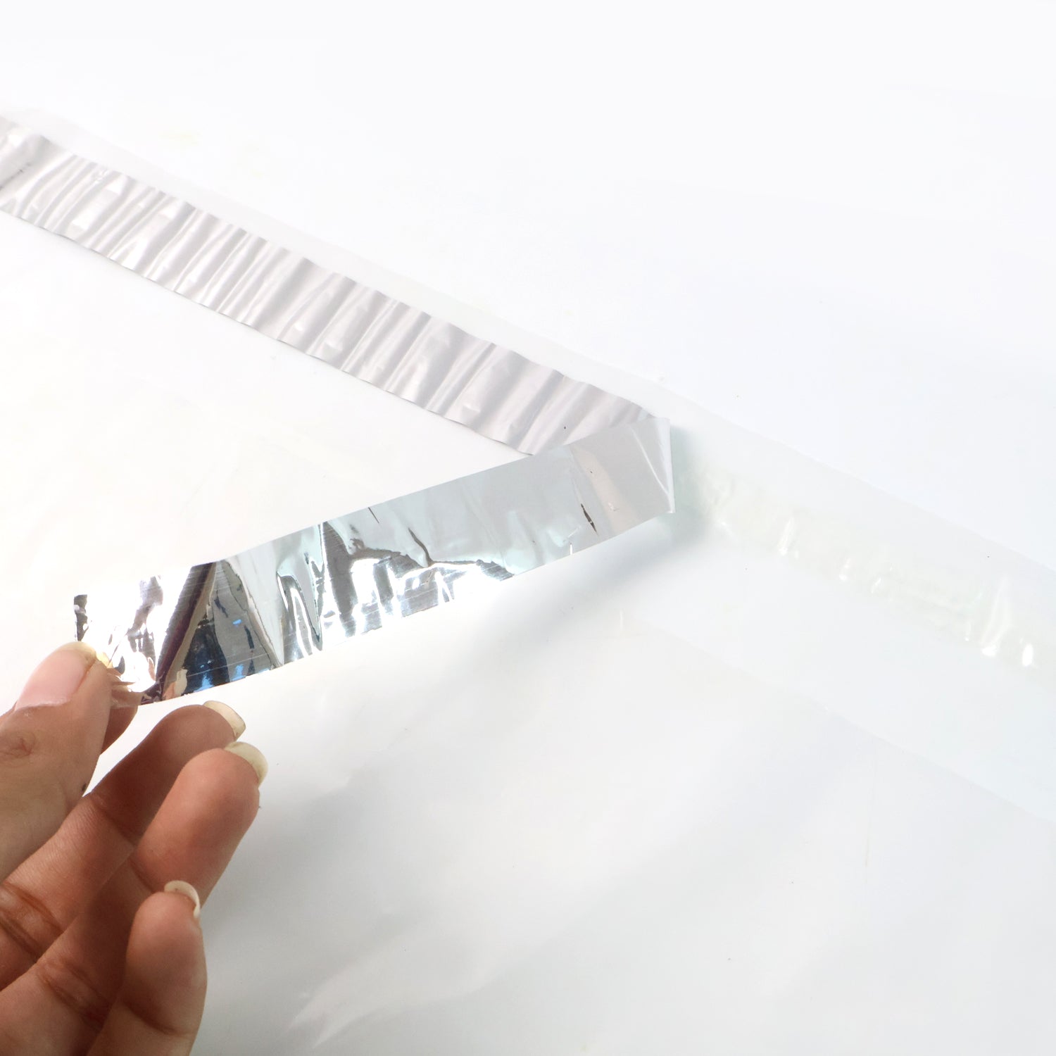 Self-adhesive flap on courier polybag ensuring tamper-proof seal