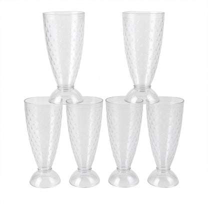 Transparent plastic milkshake glasses neatly arranged on a dining table
