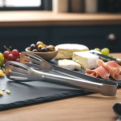 Salad being served using stainless steel kitchen serving tongs