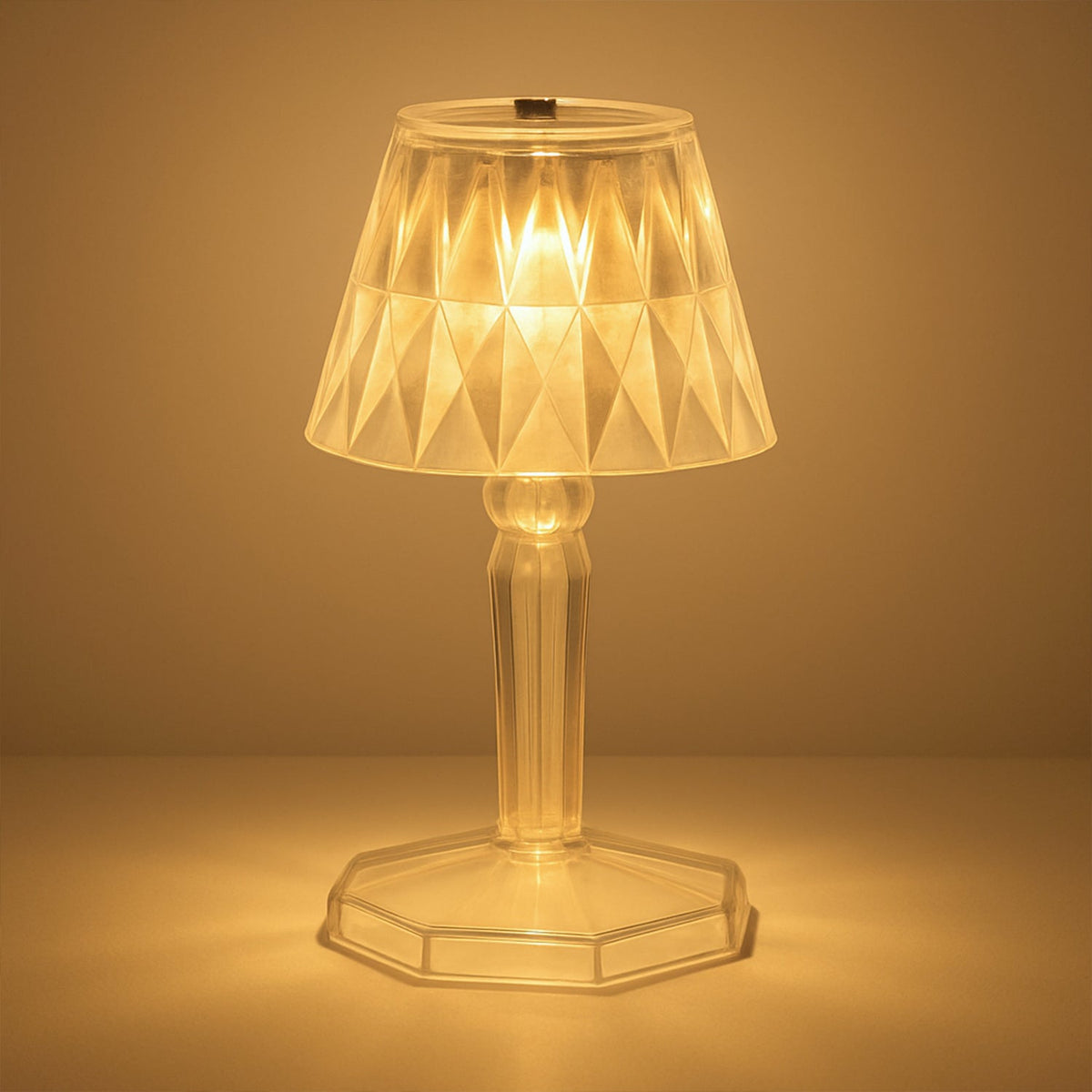 A detailed view of the acrylic crystal table lamp on a wooden surface.