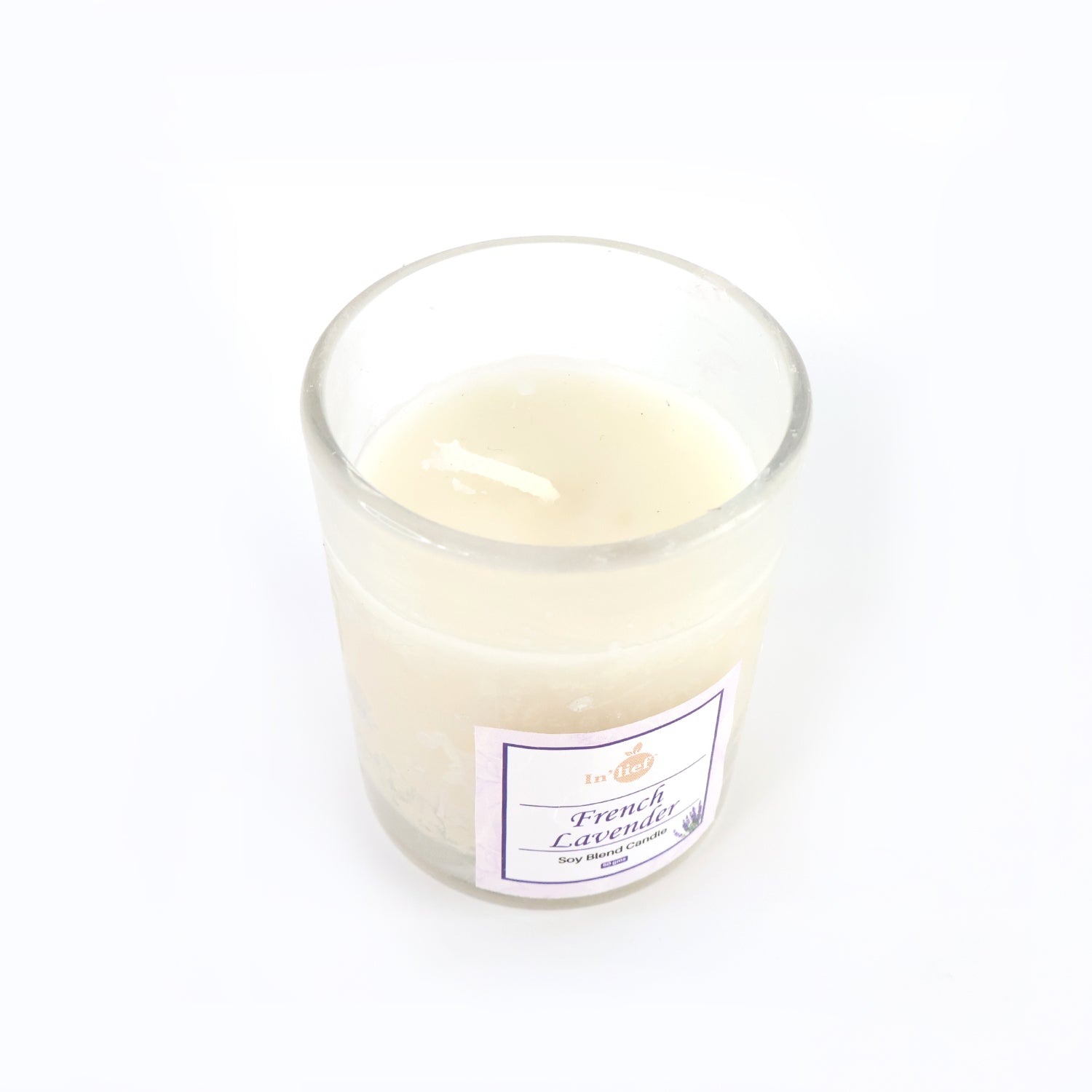 Top view of French Lavender soy candle glowing with warm flame