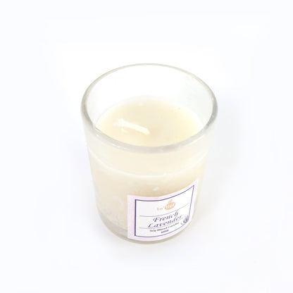 Top view of French Lavender soy candle glowing with warm flame
