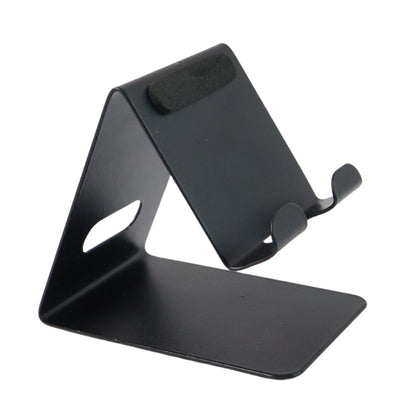 Phone holder placed on table providing stable support for a mobile device