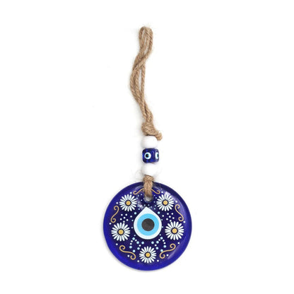 Detailed view of Evil Eye Wall Hanging's blue eye and ornamental bead accents