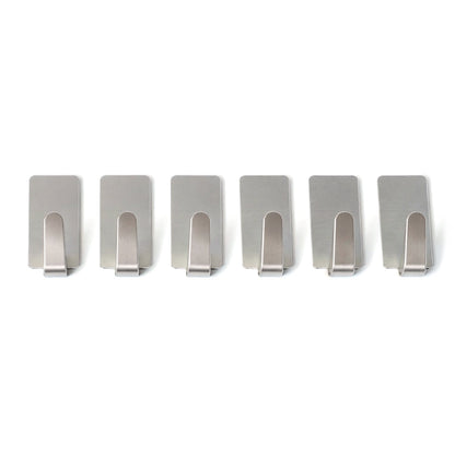 Wall hooks hanging keys and towels in home setting