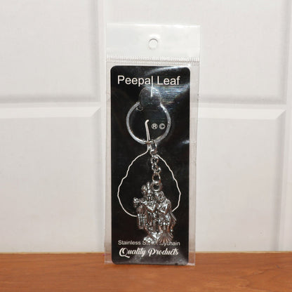Back view of Radha Krishna metal keychain showing craftsmanship
