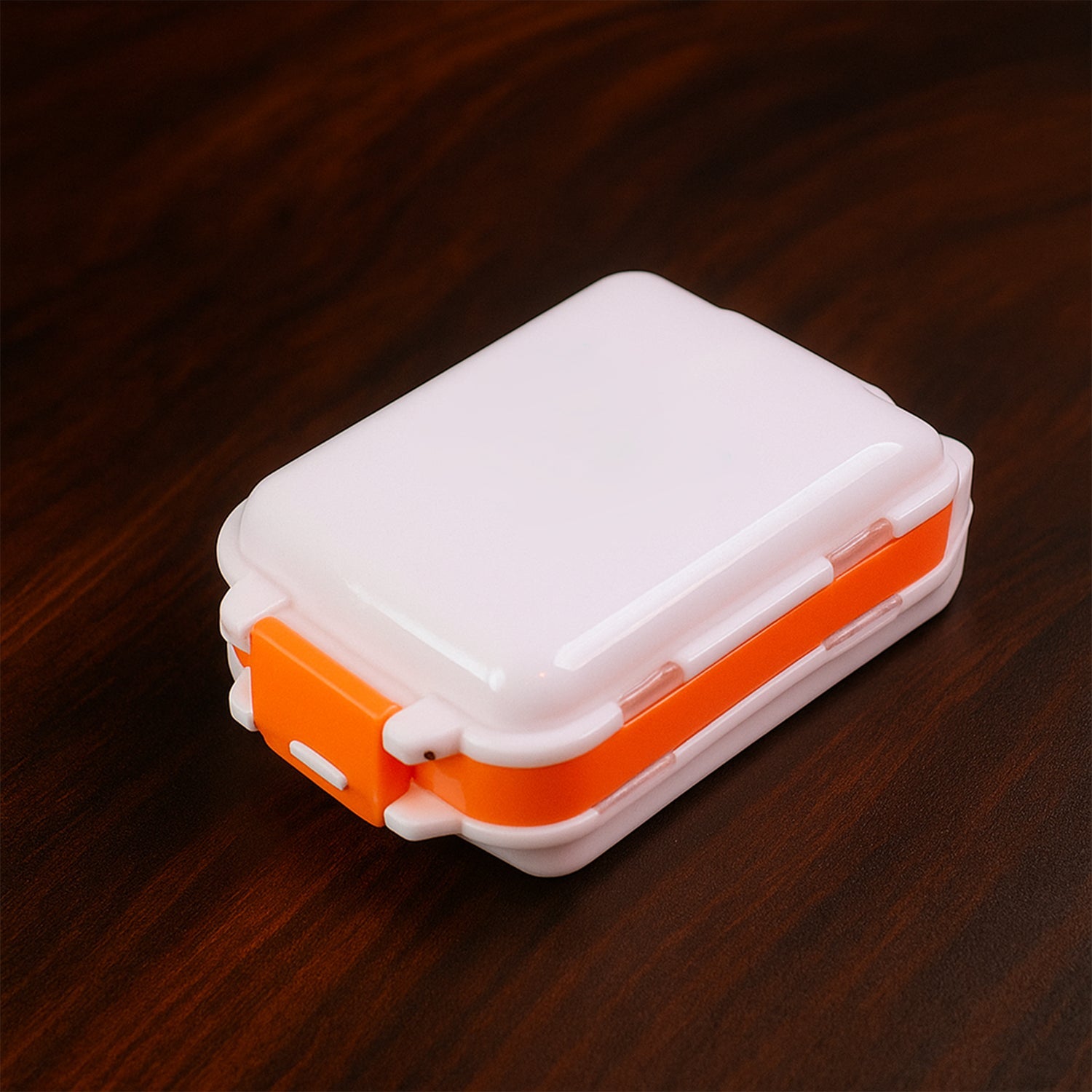 Portable pill organizer showing bright translucent lids for easy content viewing