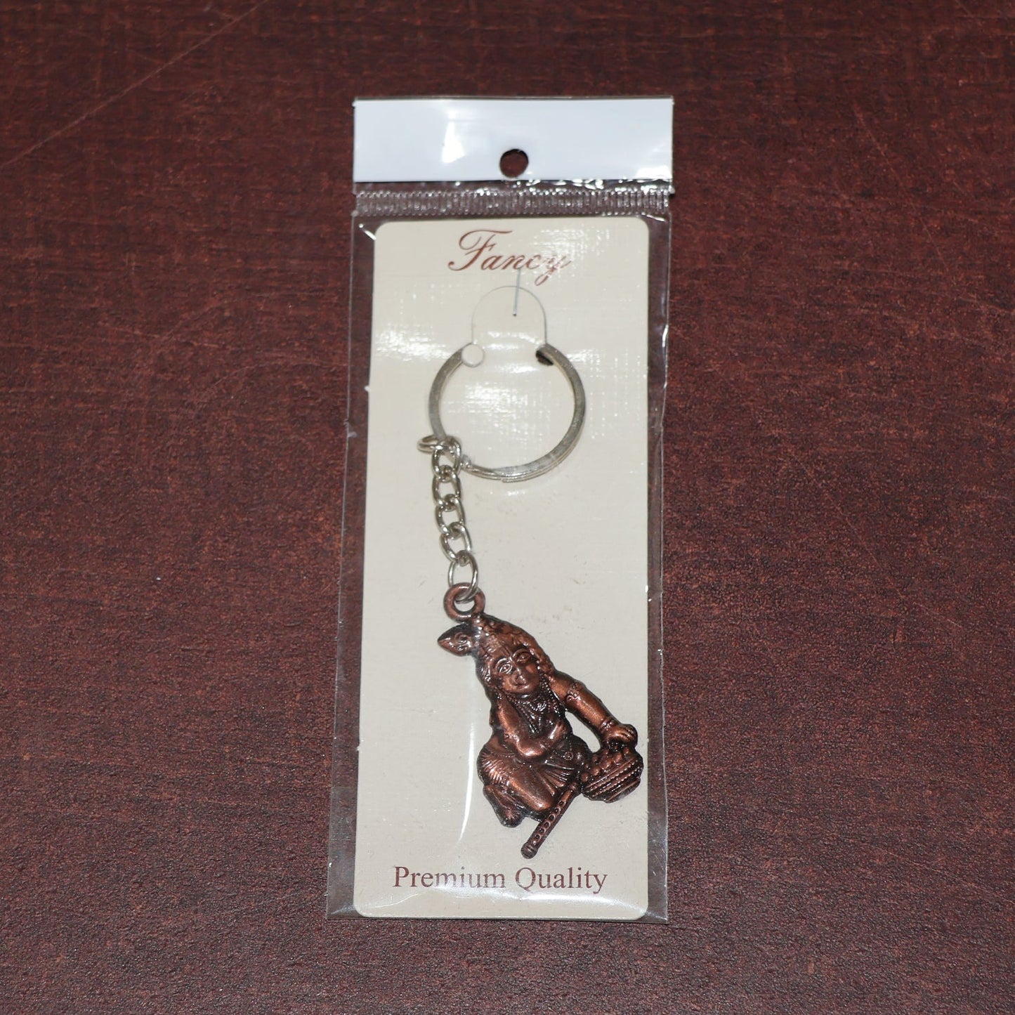 Side view of Bal Krishna metal keychain with sturdy chain and ring