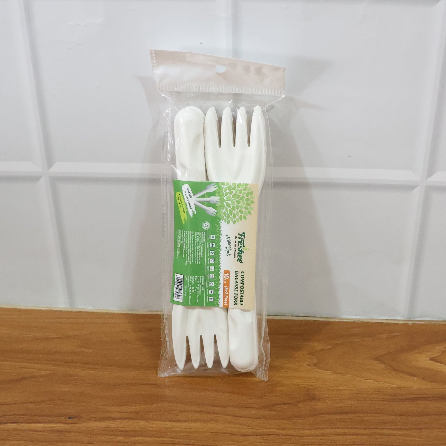 Hand holding compostable bagasse fork demonstrating convenience and durability