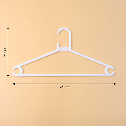 White plastic clothes hanger supporting a hanging garment