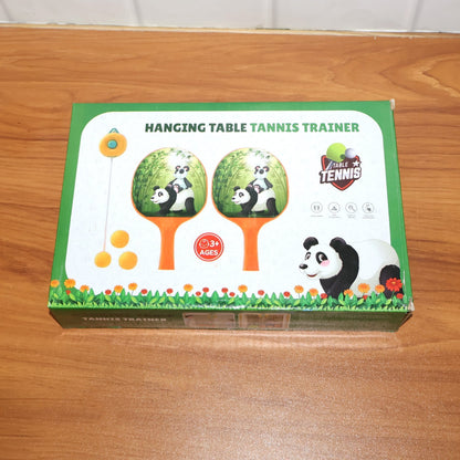 Child holding a panda-themed paddle from the hanging table tennis trainer set