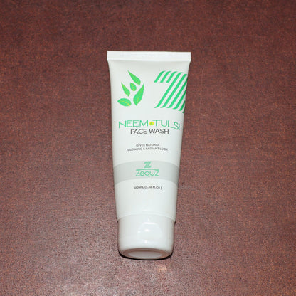 Zequz face wash tube with natural Neem and Tulsi leaves background