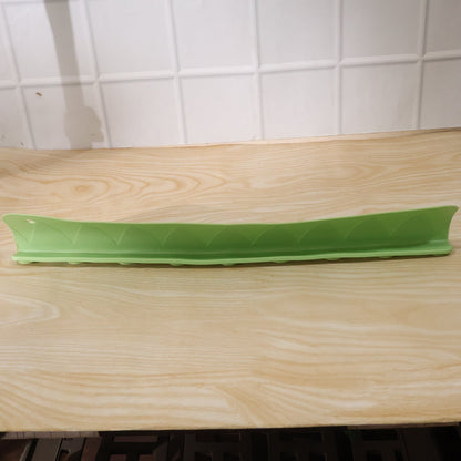 Side angle view of the flexible kitchen sink splash guard on a wooden counter.