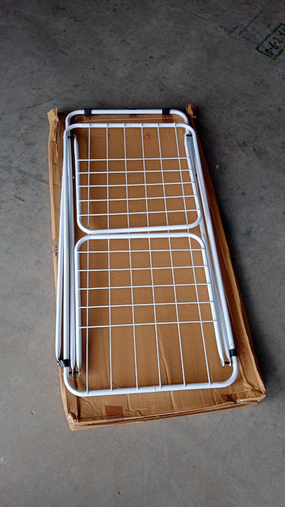 Portable foldable laundry drying stand with cross-leg base on balcony
