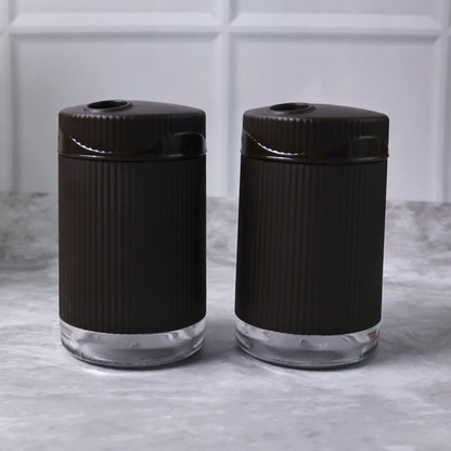 Salt and pepper dispenser set featuring transparent bases for easy spice monitoring