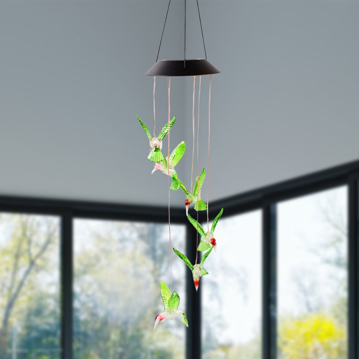 Multicolor LED glowing hummingbird wind chime shining at night