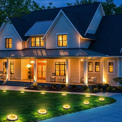 Pack of 4 solar ground lights on garden lawn