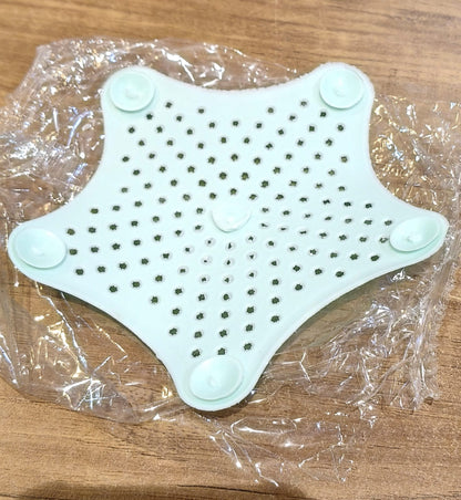 Star shaped silicone sink strainer protecting kitchen sink from hair and debris