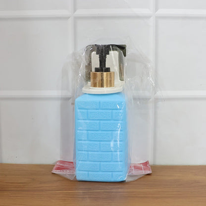 Alternate angle of wall-mounted liquid soap dispenser mounted on wall