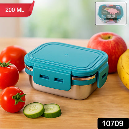 Open stainless steel mini food container filled with berries and nuts