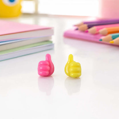 Pink and yellow thumb cable holder on desk