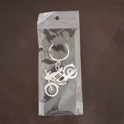 Lifestyle shot of a motorcycle silhouette metal keychain attached to a set of keys.