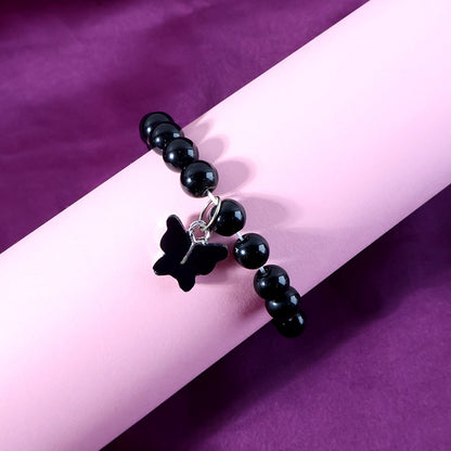 Butterfly charm and elastic band details of beaded bracelet