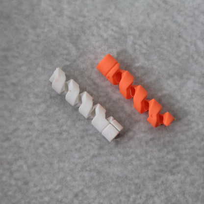 Flexible spiral cable protector in an uncoiled state, ready for installation.