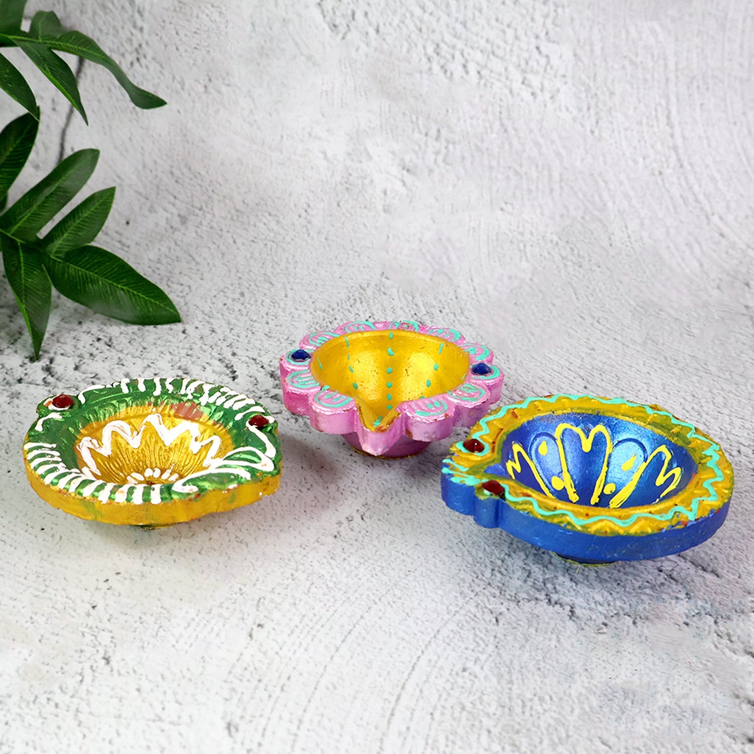 Assorted hand-painted clay diya set showcasing vibrant colors and artistic finish