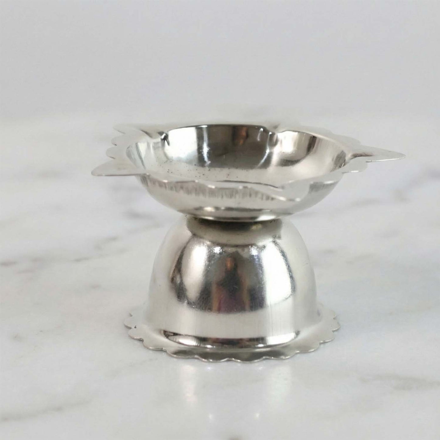 Compact decorative steel diya stand with sunflower design for rituals