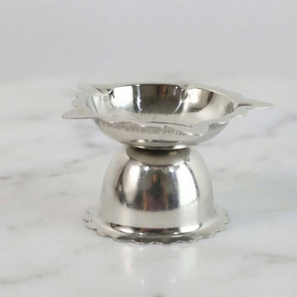 Compact decorative steel diya stand with sunflower design for rituals